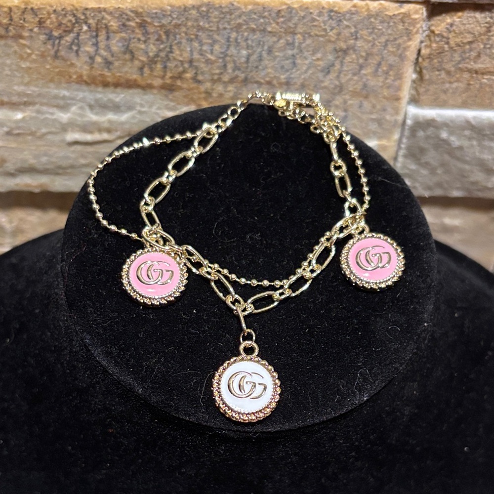 Gold, White and Pink GG double strand charm bracket